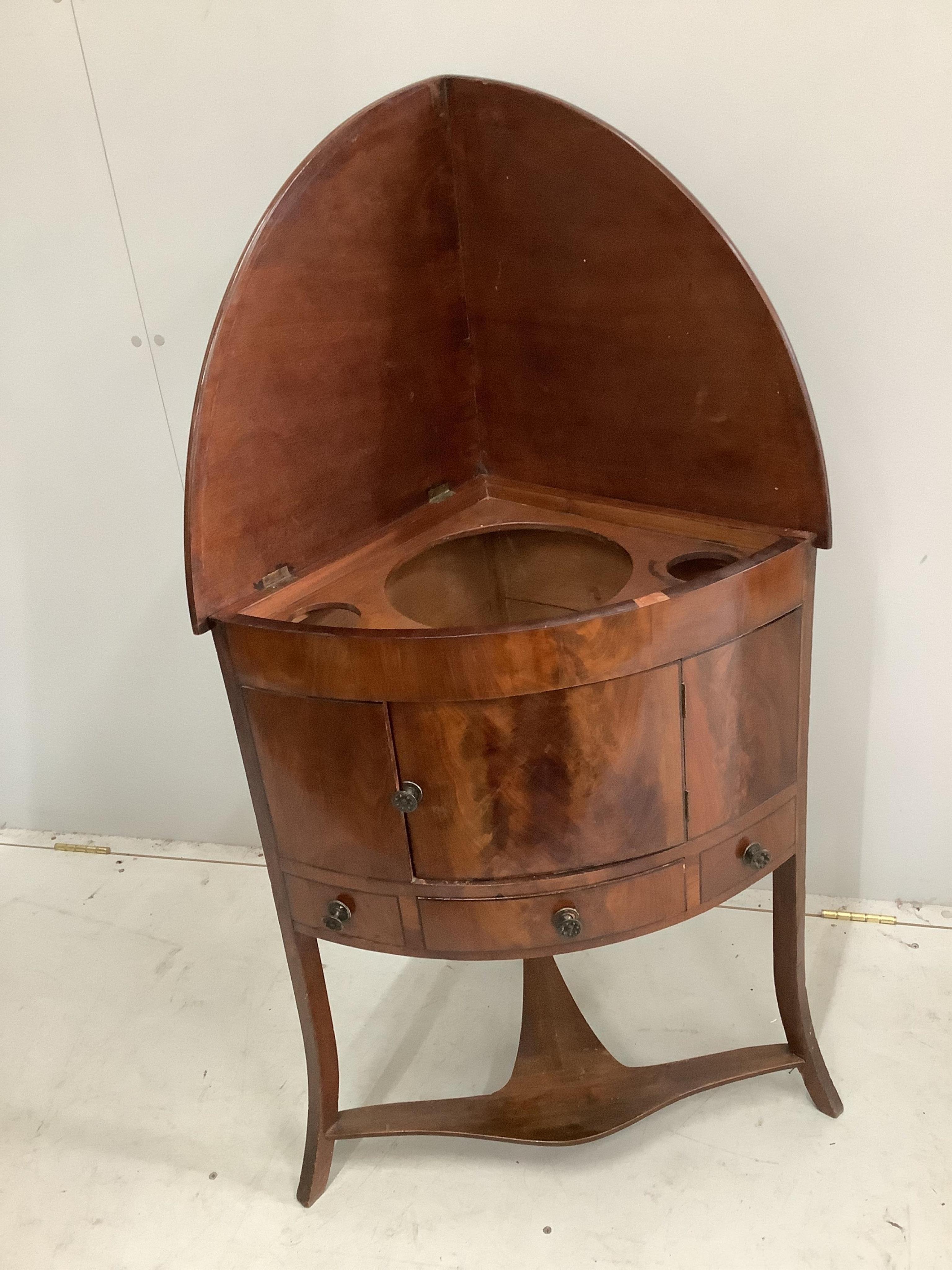 A George III mahogany corner washstand, width 64cm. Condition - fair to good